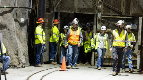 A group leaves the Ross Cage at the 4850 Level Ross Station at SURF