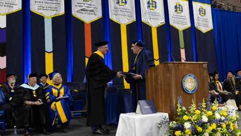 Mike Headley receiving an honorary doctorate from SDSU. 