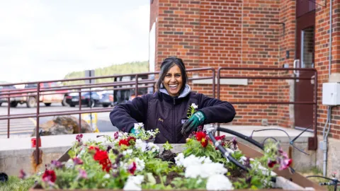 Mandy Knight plants flowers during the 2026 annual clean-up day at SURF. 
